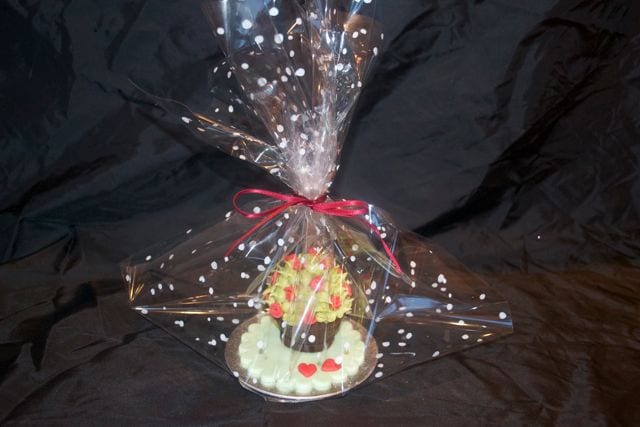 Gift wrapped Valentine's Gift icing covered creme egg wrapped in spotty cellophane