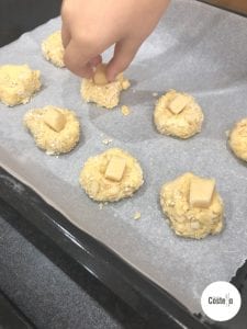 Adding the marzipan to melting moments before baking