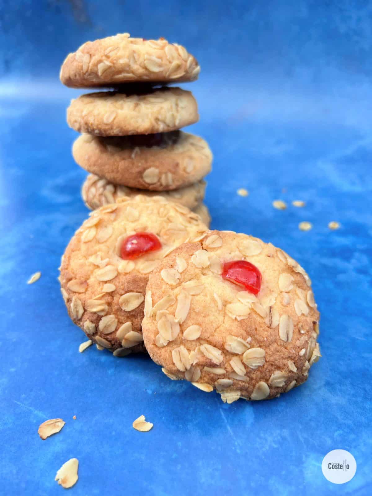 A stack of vanilla melting moments cookies with a cherry on top